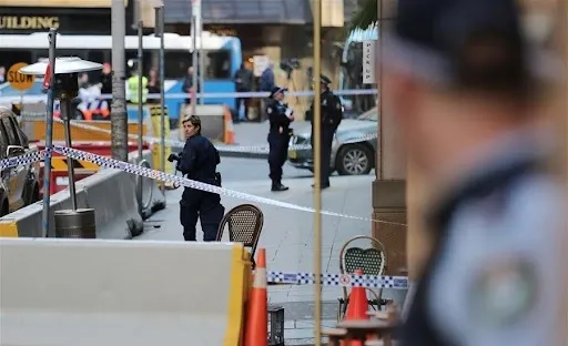 Why was a man charged over the alleged stabbing of two neighbors in Sydney?