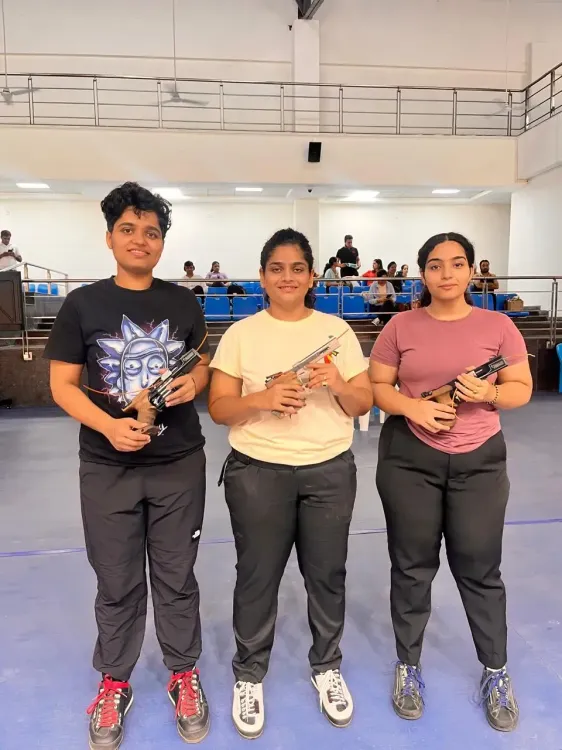 Who topped at the National Shooting Trials in Dehradun?