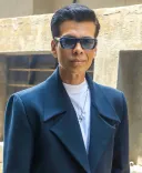 Is the audio medium easier or more challenging for Karan Johar than the visual medium?